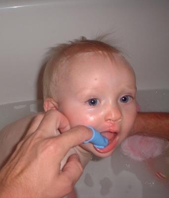 Work you way over to the right side. You'll also notice that I'm in the tub. Seems to work best for me, less droll for pops to clean up later. Rinse brush out and let dry and place in clean container. Make a habit of brushing on each bath, teaches Stella good hygiene!