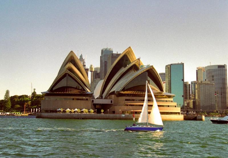 Sailboat passing the Sydney Opera House