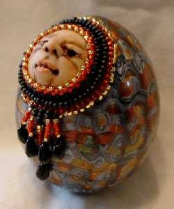 Egg rattle with beaded face.  He's made with a chicken egg.