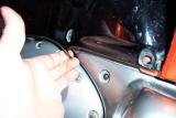 Pull the black plastic portion forward to allow the lower cowl to slip out