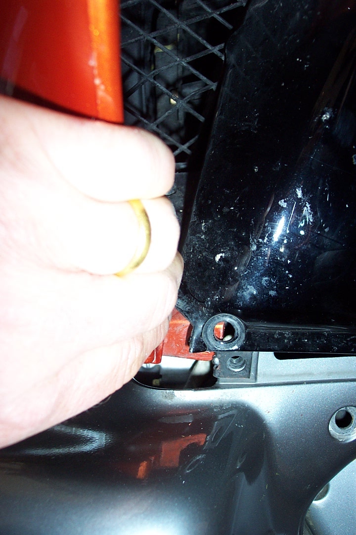 By grasping the side of the fairing side panel, you can pull it out just enough to free the tab for the lower cowl