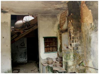 a partly collasped roof.  With the stove and chimney on the right.