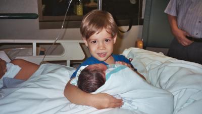 Big brother Ben holding Evan for the first time