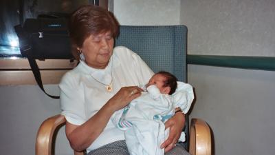 Tricia's mom, Lola, holding Evan in the hospital