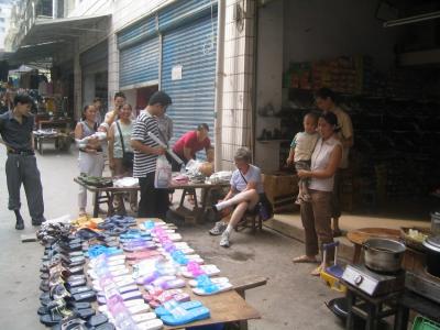 Carol buying shoes in the Fengdu Market.JPG