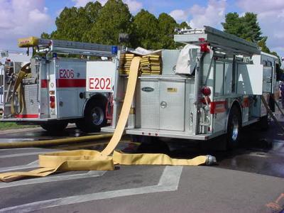 80. E202 two fire trucks big yellow hose and other hoses