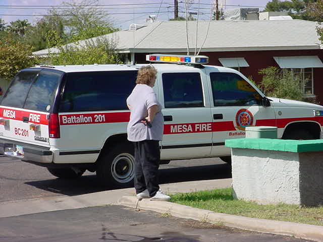 57. Phyllis standing next to small support firetruck on Harris