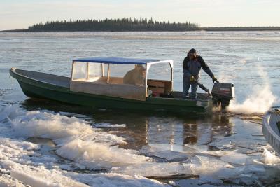 Boat taxi coming to shore through ice