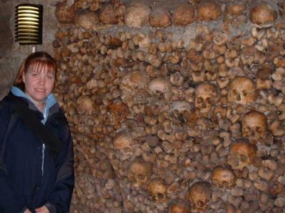 Nicki posing infront of the wall which has a heart made of skulls