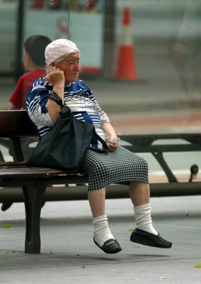 Old lady, possibly listening for the racing results!