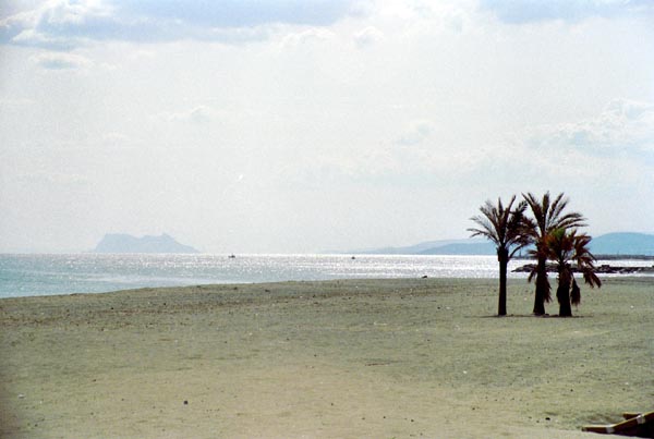 The Rock of Gibraltar in the distance from a beach on the Costa del Sol
