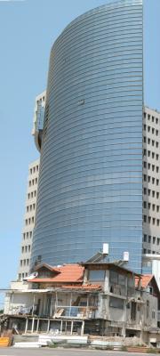 Modern office building with an old structure at its feet