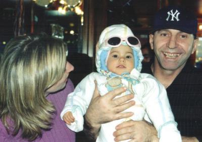 Dagny and Giovanni (owner) greet a baby who came in for a slice of pizza