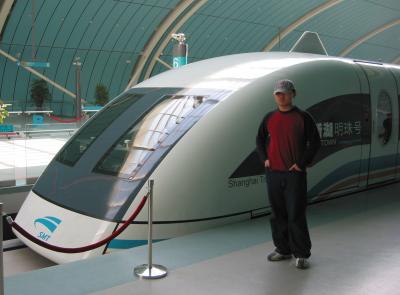 Young Chinese proudly in front of the speed train.jpg