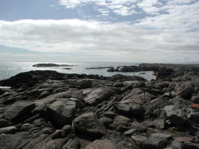 Rocky coast with mountains and lighthouse