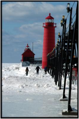 Lighthouse and Pierpeople walk the pier
