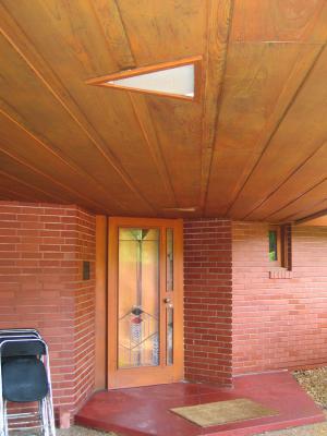 Entry.  The red porch material runs right into and throughout the house for flooring.