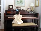 Playing the piano her Mother & Grandmother played on as children.