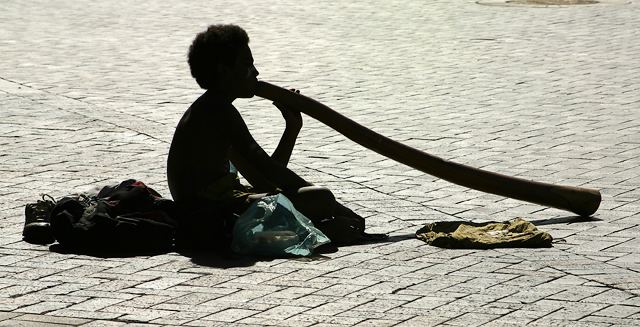 Silhouette of busker with didge