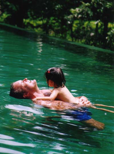 Mia and Daddy in the pool swimming together.jpg