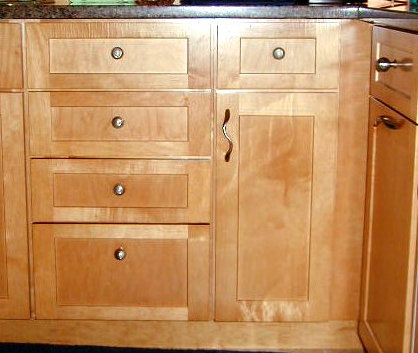 Put drawer hdwr. 3/8 above vertical center.  If mounted dead center, they look low when you are standing looking down on them.