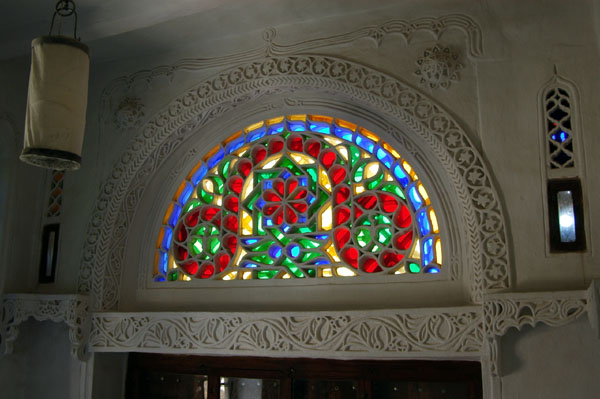Colorful takhrim (qamariya) window at Dar al-Hajar, Yemen