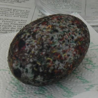 An egg waiting to have the wax removed.