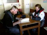 Martin (naturalist) and Monika (expedition leader) signing Danco Island guest book