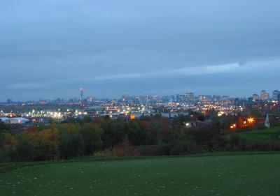 View of city lights at dusk from the green on hole 7