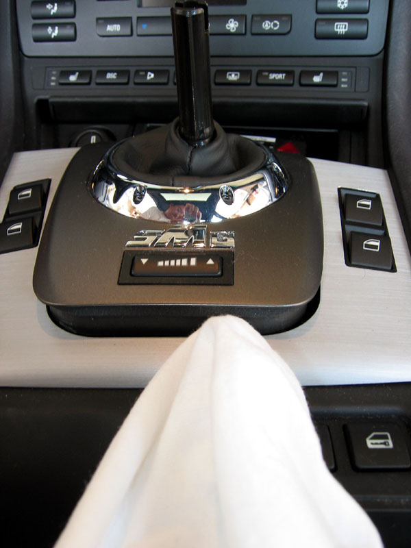 Use a cloth covered screw driver to pop the shifter plate up