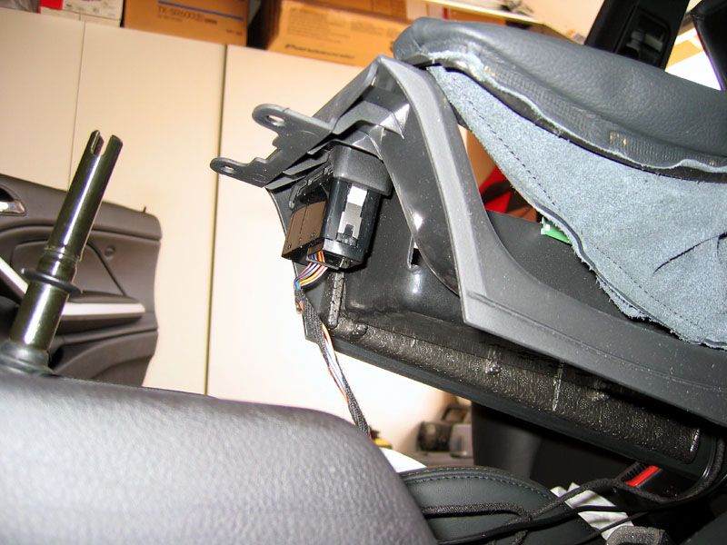 Lift the front part of the center console then disconnect the connector for the hazard and power door lock