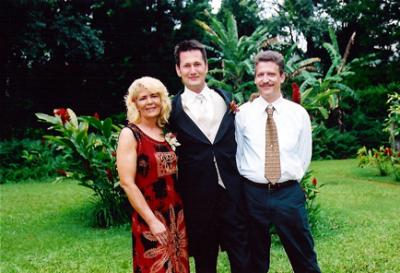 Justin with his Mom and her husband Mike.JPG