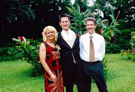 Justin with his Mom and her husband Mike.JPG