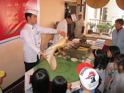 29745-At lunch girls watch Thai pancake maker.jpg