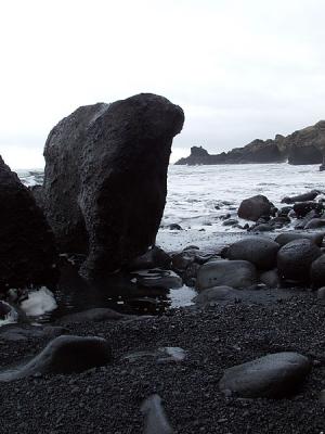 black volcanic beach with boulders