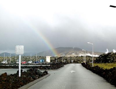 rainbow over volcanic landscape