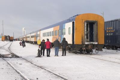 Passengers wait by end of mixed train