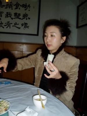 Ms Ada demostrating how to eat Peking Duck.