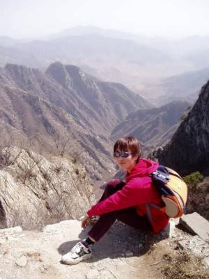 Judy sitting bravely on top of Tian Ti. Behind her is a chasm of unknown depth.