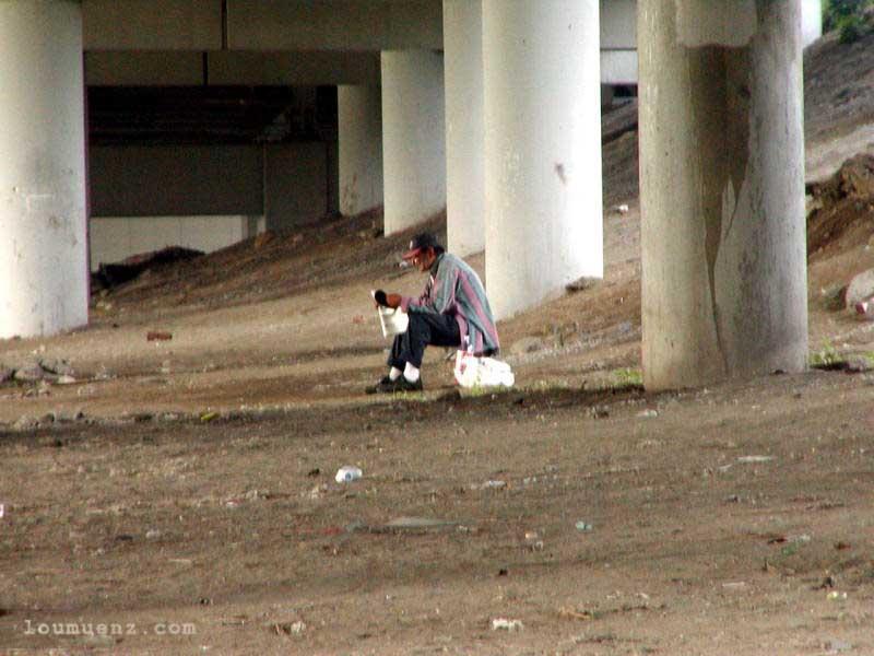 "John" Reading The Paper Under The Main Ave. Bridge