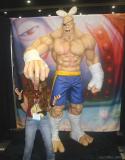 Sagat from Street Fight stole this little girls bunny ears and is going to crush her head.