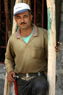 Builder with hammer and cigarette