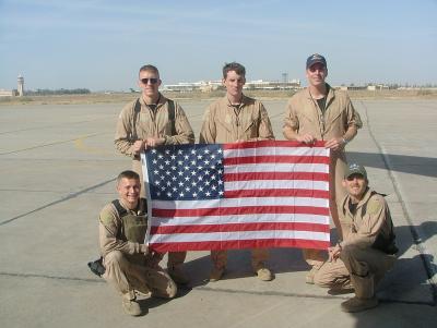 crew with flag at baghdad.jpg