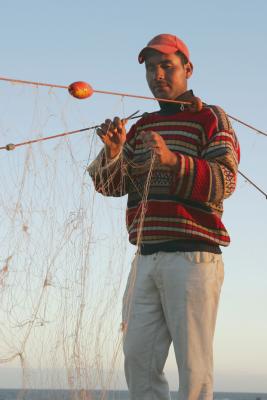 Fisherman repairing nets