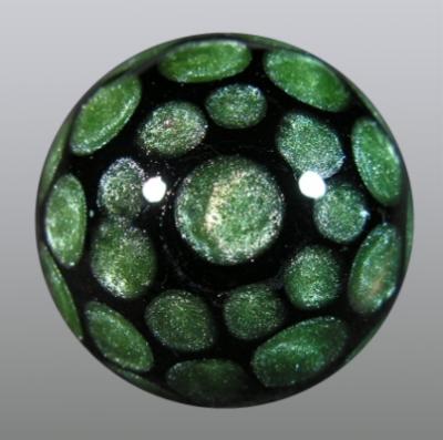Green moss dots over black adorn the backside.