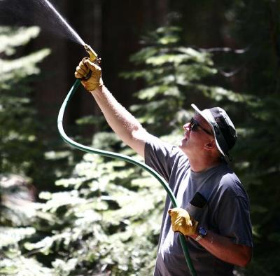 Wetting down the trees above the fire