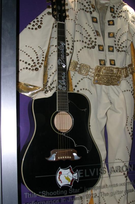 replica of Elvis Gibson dove guitar and a jump suit