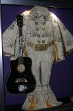 replica of Elvis Gibson dove guitar and a jump suit