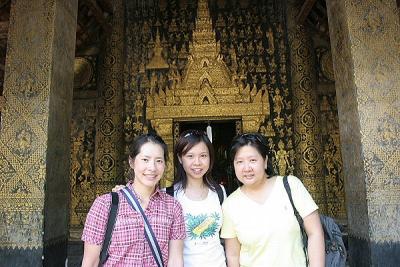Jane, Joyce, and Noon at entrance to Wat Xieng Thong