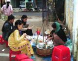 Students are taking the Breakfast on street side restaurant in hue